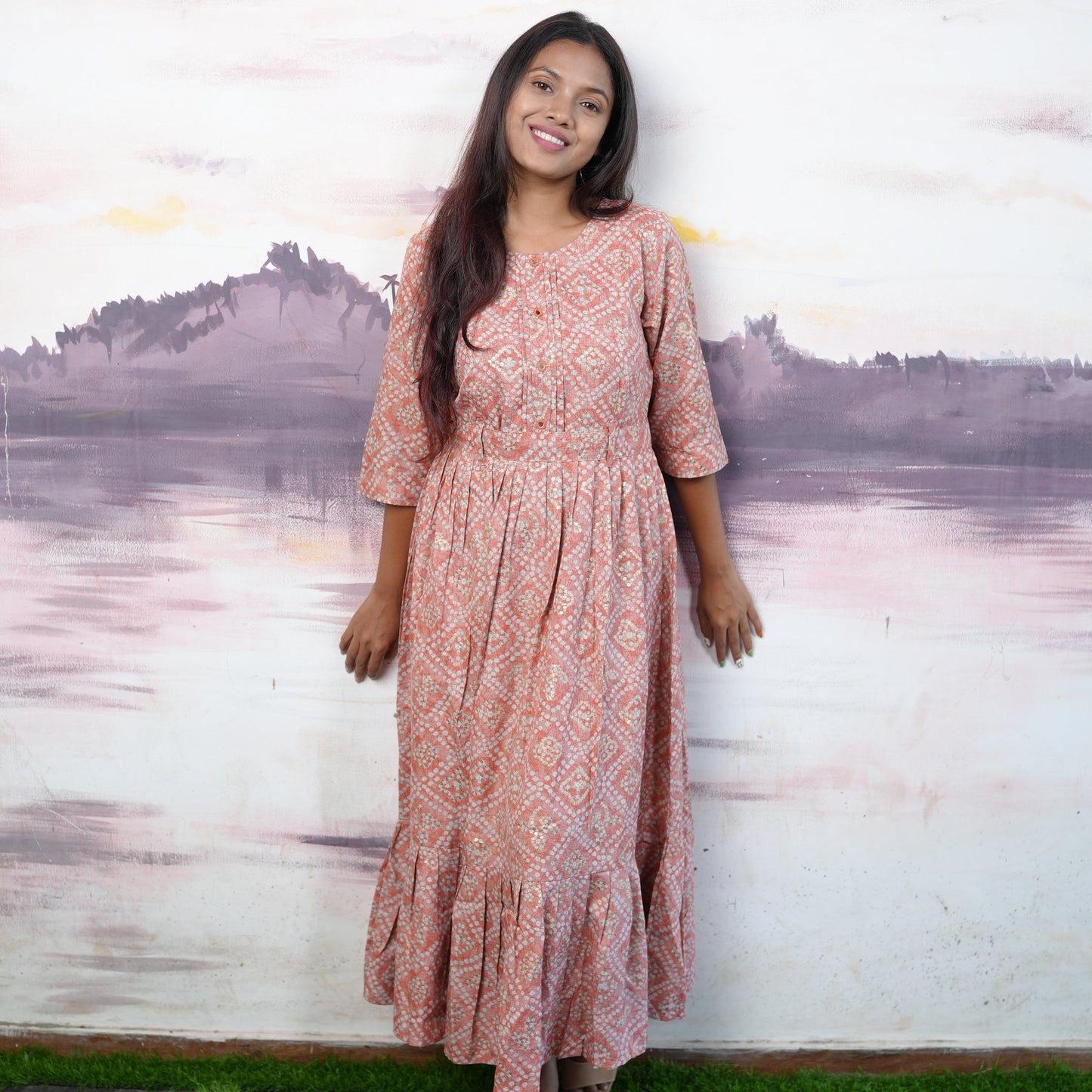 Flared cotton salmon coloured Kurti with beautiful mirror work and belt.