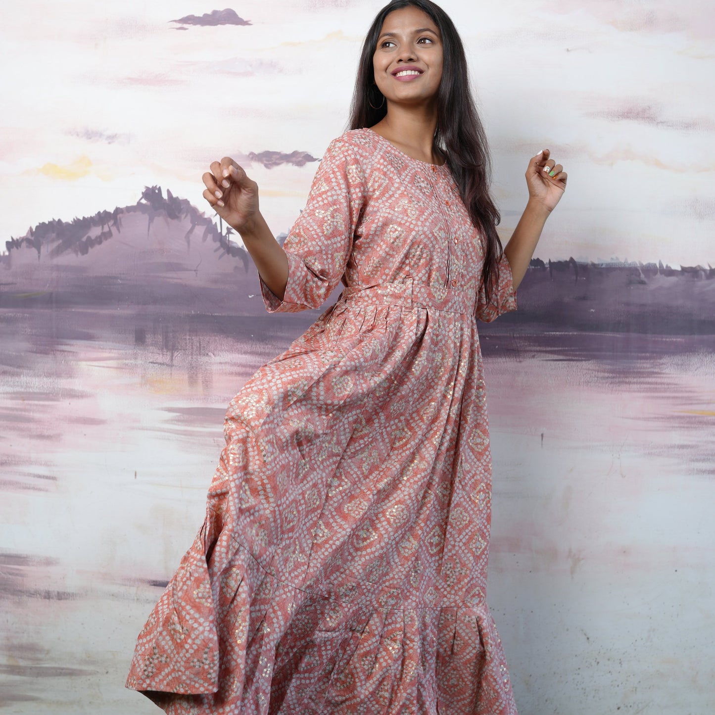 Flared cotton salmon coloured Kurti with beautiful mirror work and belt.