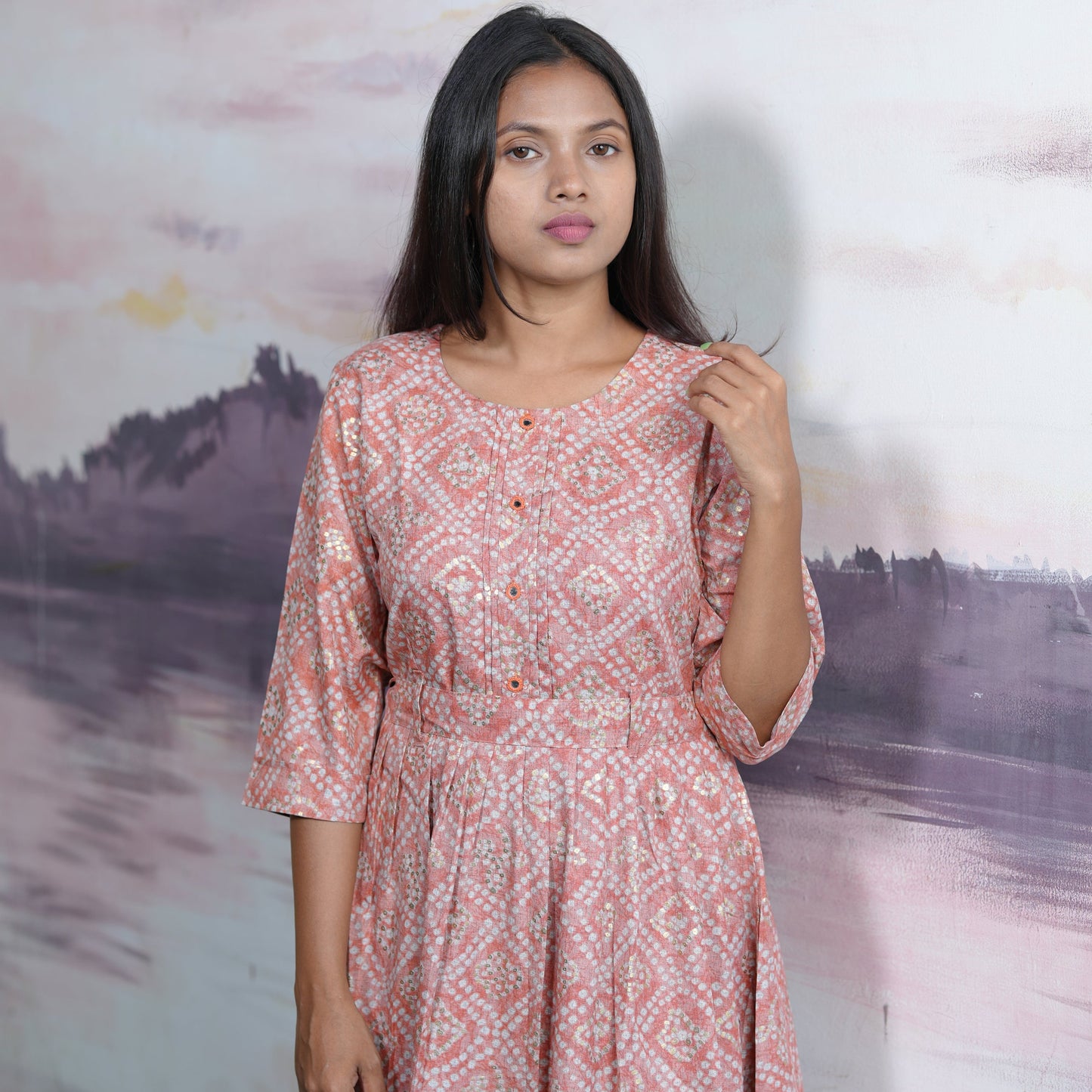 Flared cotton salmon coloured Kurti with beautiful mirror work and belt.