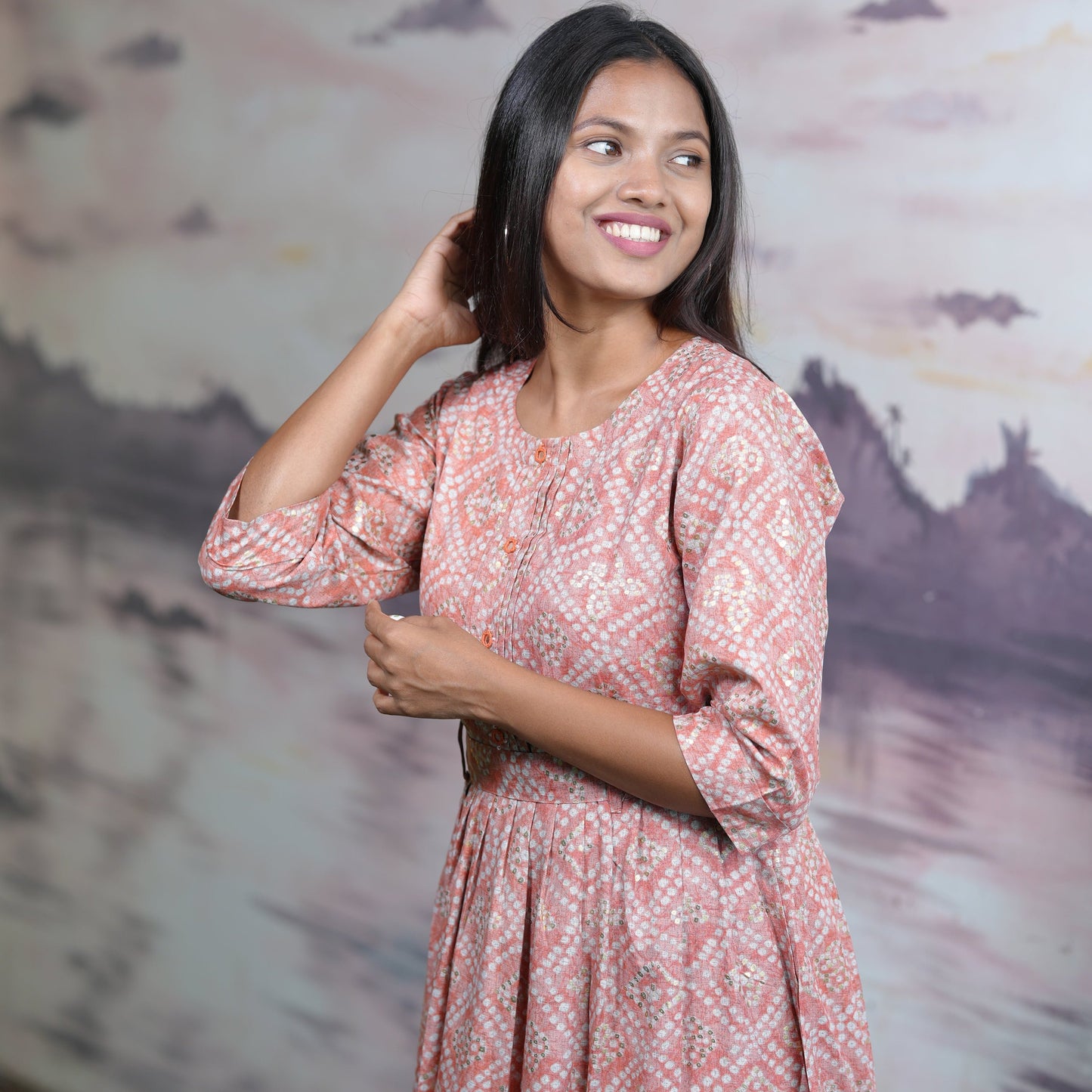 Flared cotton salmon coloured Kurti with beautiful mirror work and belt.