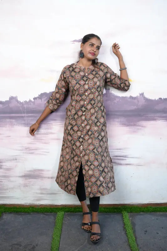 Collared rayon A-line princess cut Kurti with golden and red print work on a black base.