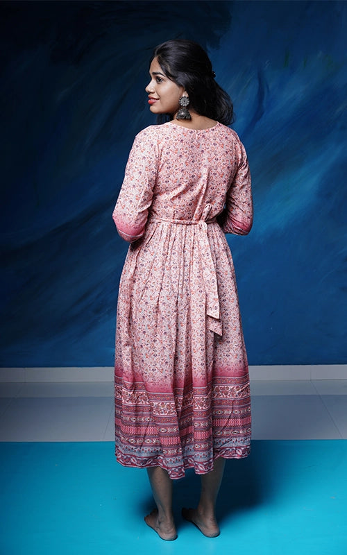 Flared salmon pink poly muslin Kurti with mirror work yoke with back tie detail.