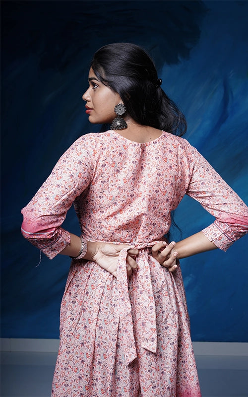 Flared salmon pink poly muslin Kurti with mirror work yoke with back tie detail.