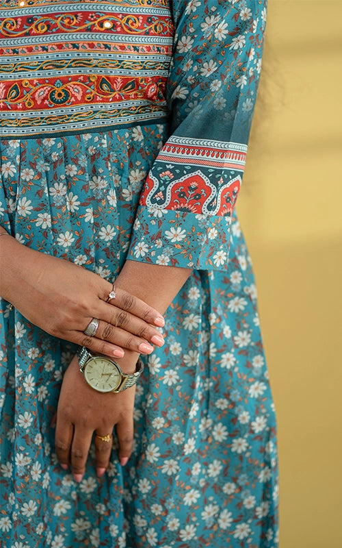 Deep teal color flared poly muslin kurti with mirror embellished yoke with back tie detail