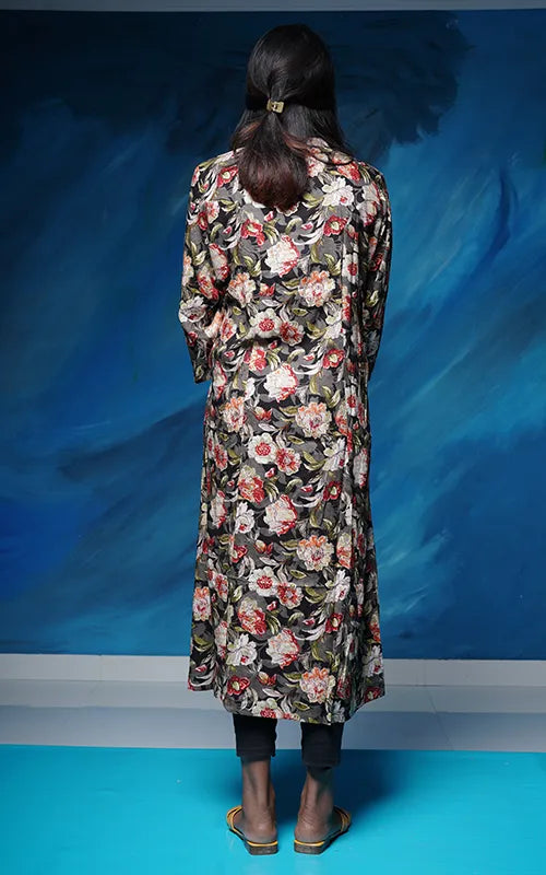 A-line princess cut rayon kurti with side pockets with floral design on a grey black base.