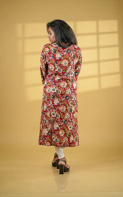 A-line princess cut rayon kurti with side pockets with floral design on a maroon base.