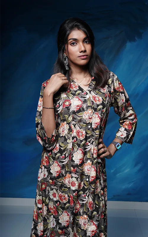 A-line princess cut rayon kurti with side pockets with floral design on a grey black base.