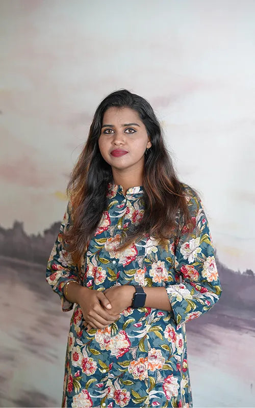 A-line princess cut rayon kurti with side pockets with floral design on a bluish green base.