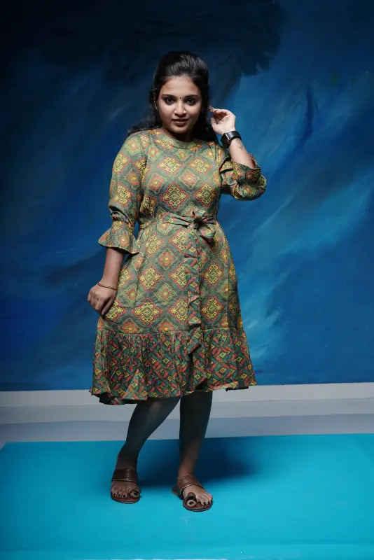 Flared short rayon Kurtis with an attached front tie in rich green colour with red and yellow work.