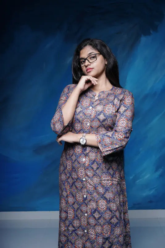 Collared rich navy blue A-line princess cut Kurti with golden print work in rayon.