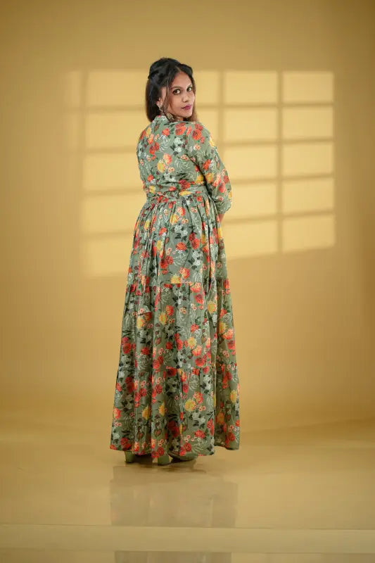 Beautiful flared pickle green coloured muslin silk gown style Kurti with floral design.