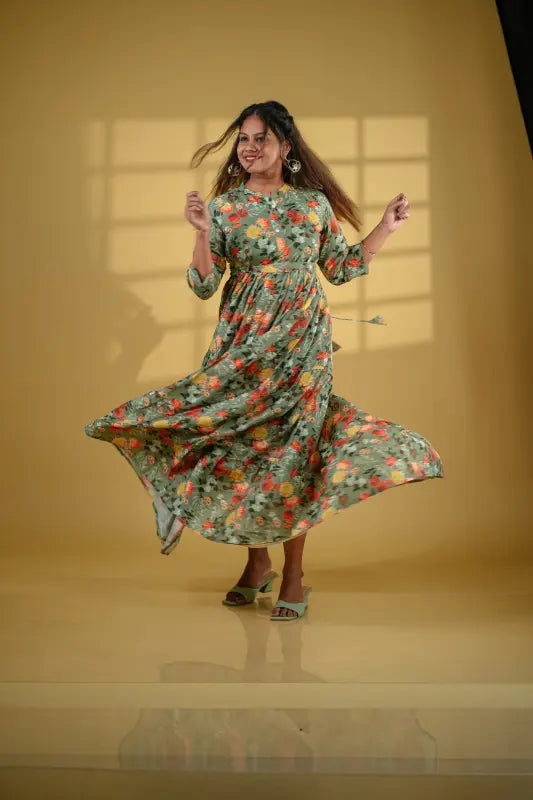 Beautiful flared pickle green coloured muslin silk gown style Kurti with floral design.