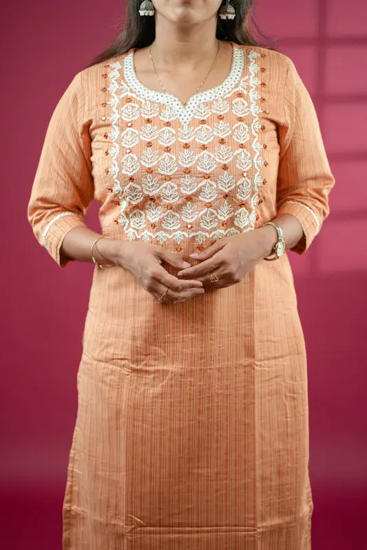 Rich caramel coloured straight side cut cotton silk Kurti with mirror and embroidery work.