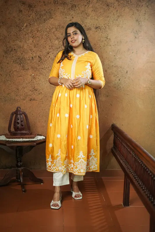 Lovely bright yellow flared Naira side cut silk Kurti with embroidery work.