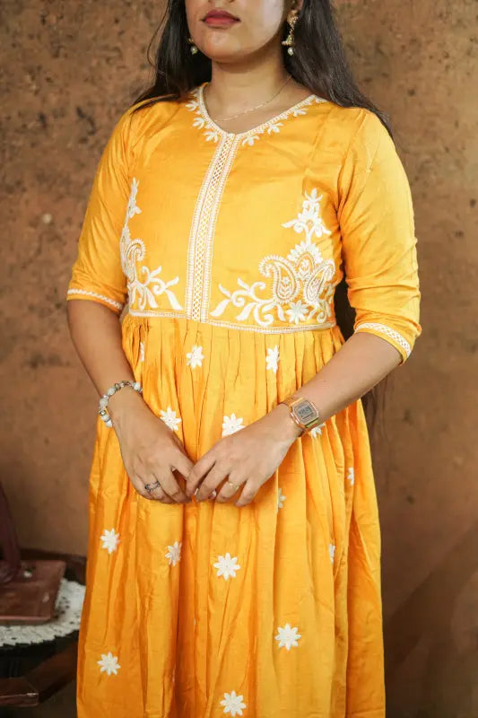 Lovely bright yellow flared Naira side cut silk Kurti with embroidery work.
