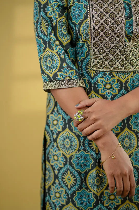 Ajrakh print black base muslin silk Kurti with mustard and turquoise print with added sequin embellished yoke.