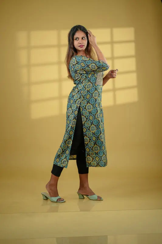 Ajrakh print black base muslin silk Kurti with mustard and turquoise print with added sequin embellished yoke.