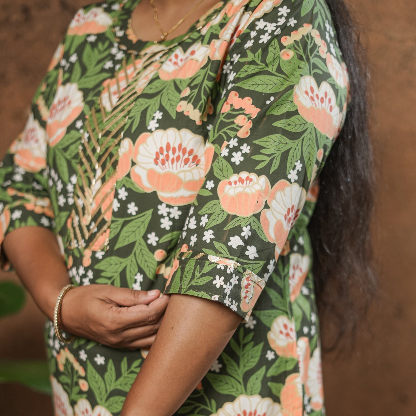 Straight cut simple pure cotton dark green Kurti with peach coloured floral print.