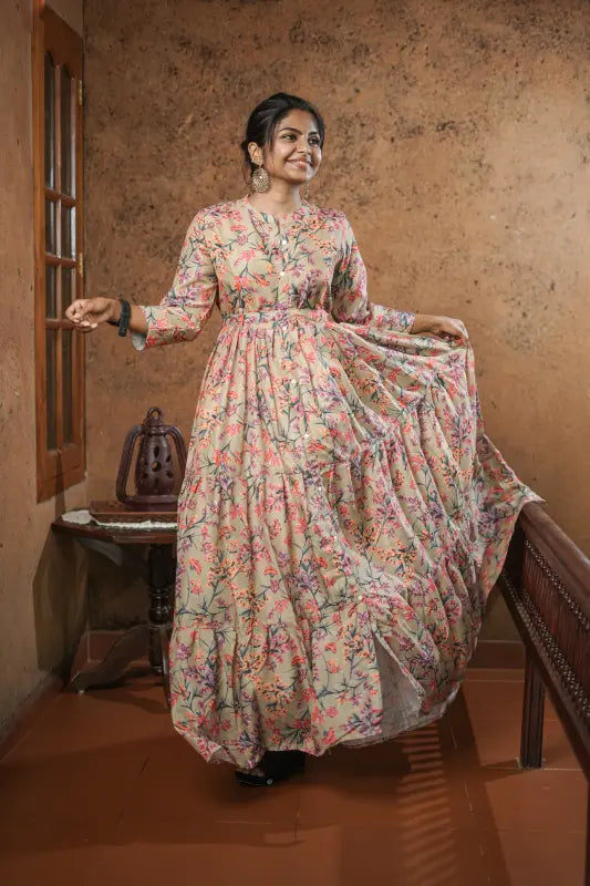 Lovely flared muslin silk gown style kurti with floral design on olive green base with belt.