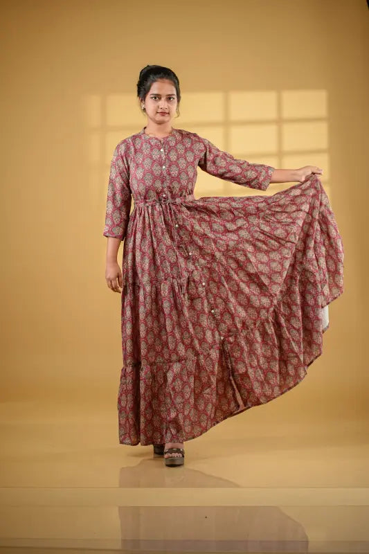 Gorgeous long flared gown style maroon muslin silk Kurti with print work.