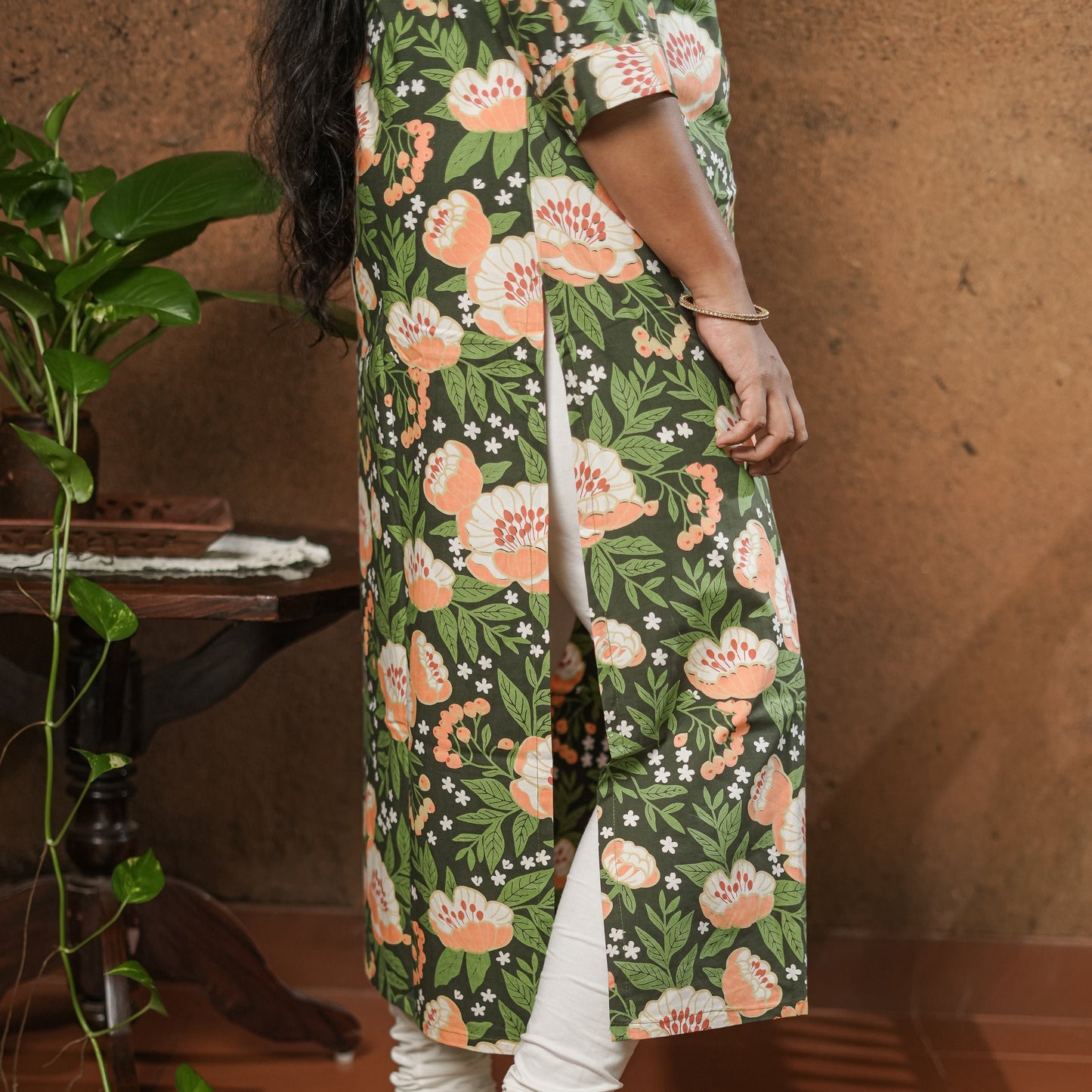 Straight cut simple pure cotton dark green Kurti with peach coloured floral print.