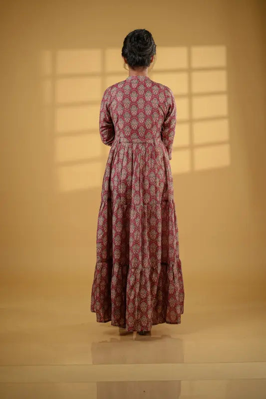 Gorgeous long flared gown style maroon muslin silk Kurti with print work.