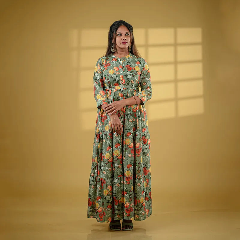 Beautiful flared pickle green coloured muslin silk gown style Kurti with floral design.