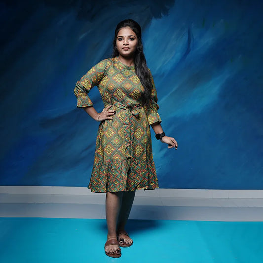 Flared short rayon Kurtis with an attached front tie in rich green colour with red and yellow work.