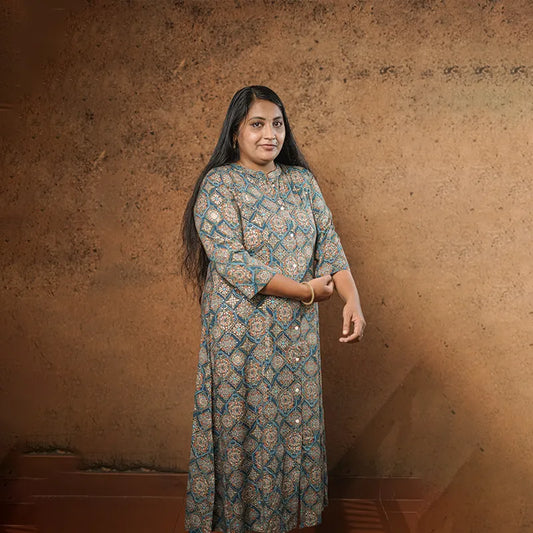 Rich golden work on teal coloured base collared rayon A-line princess cut Kurti.