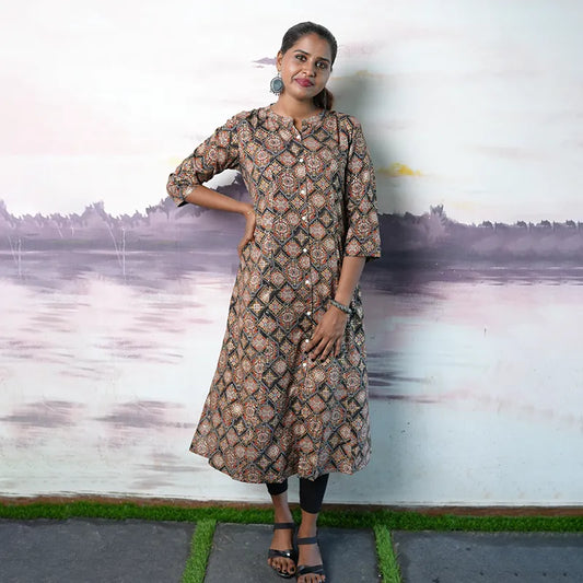 Collared rayon A-line princess cut Kurti with golden and red print work on a black base.