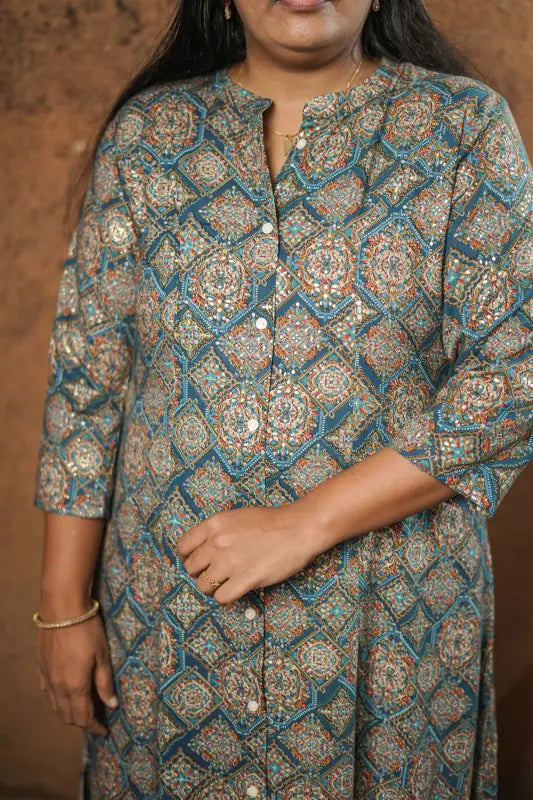 Rich golden work on teal coloured base collared rayon A-line princess cut Kurti.