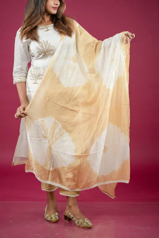Beautiful and rich white and golden silk Kurti with rich golden thread work and golden tie dye Dupatta and rich golden stylish pant.