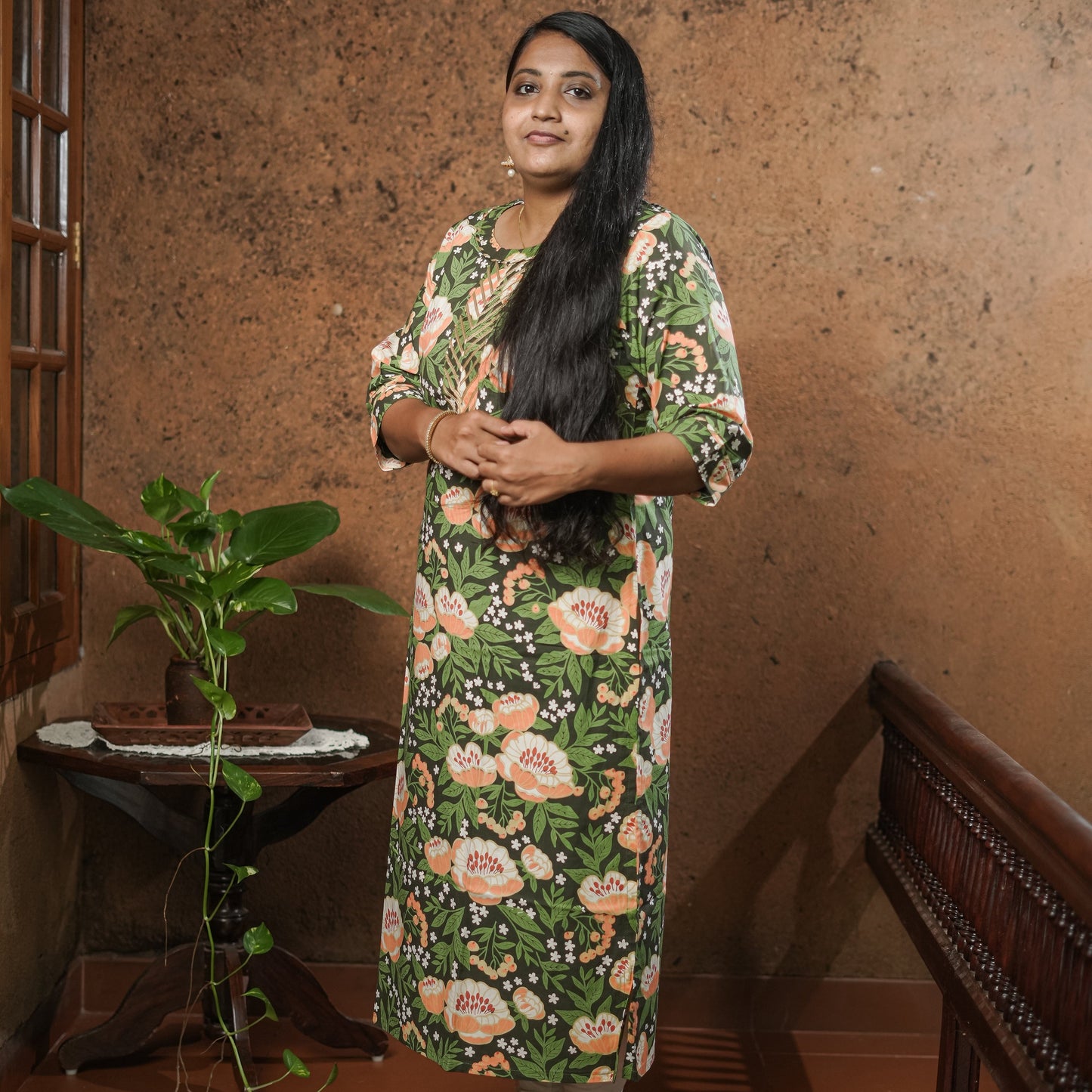 Straight cut simple pure cotton dark green Kurti with peach coloured floral print.
