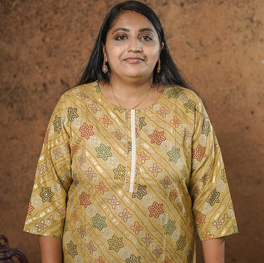 Deep mustard colour cotton Kurti with rich golden print work.