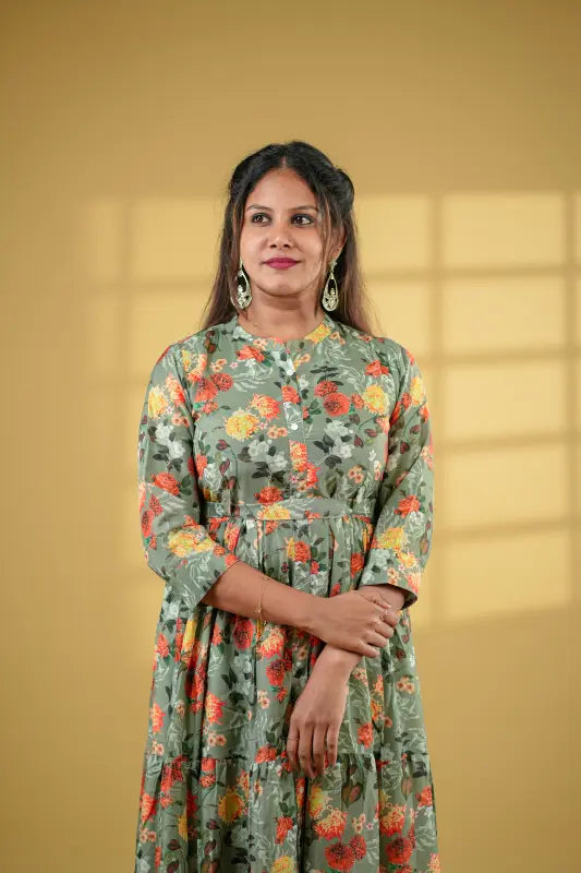 Beautiful flared pickle green coloured muslin silk gown style Kurti with floral design.