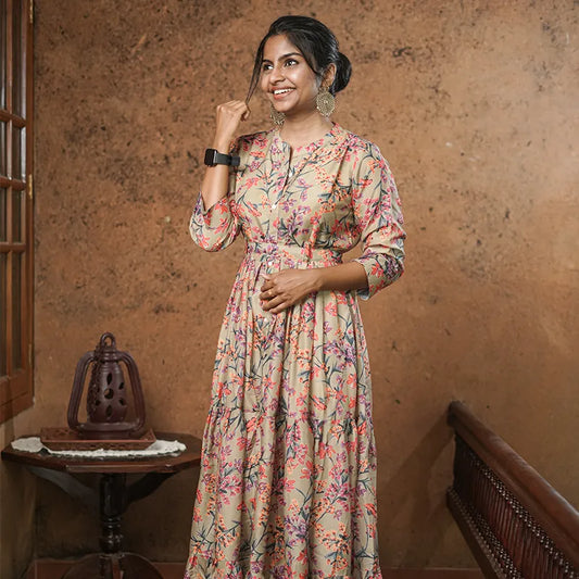 Lovely flared muslin silk gown style kurti with floral design on olive green base with belt.